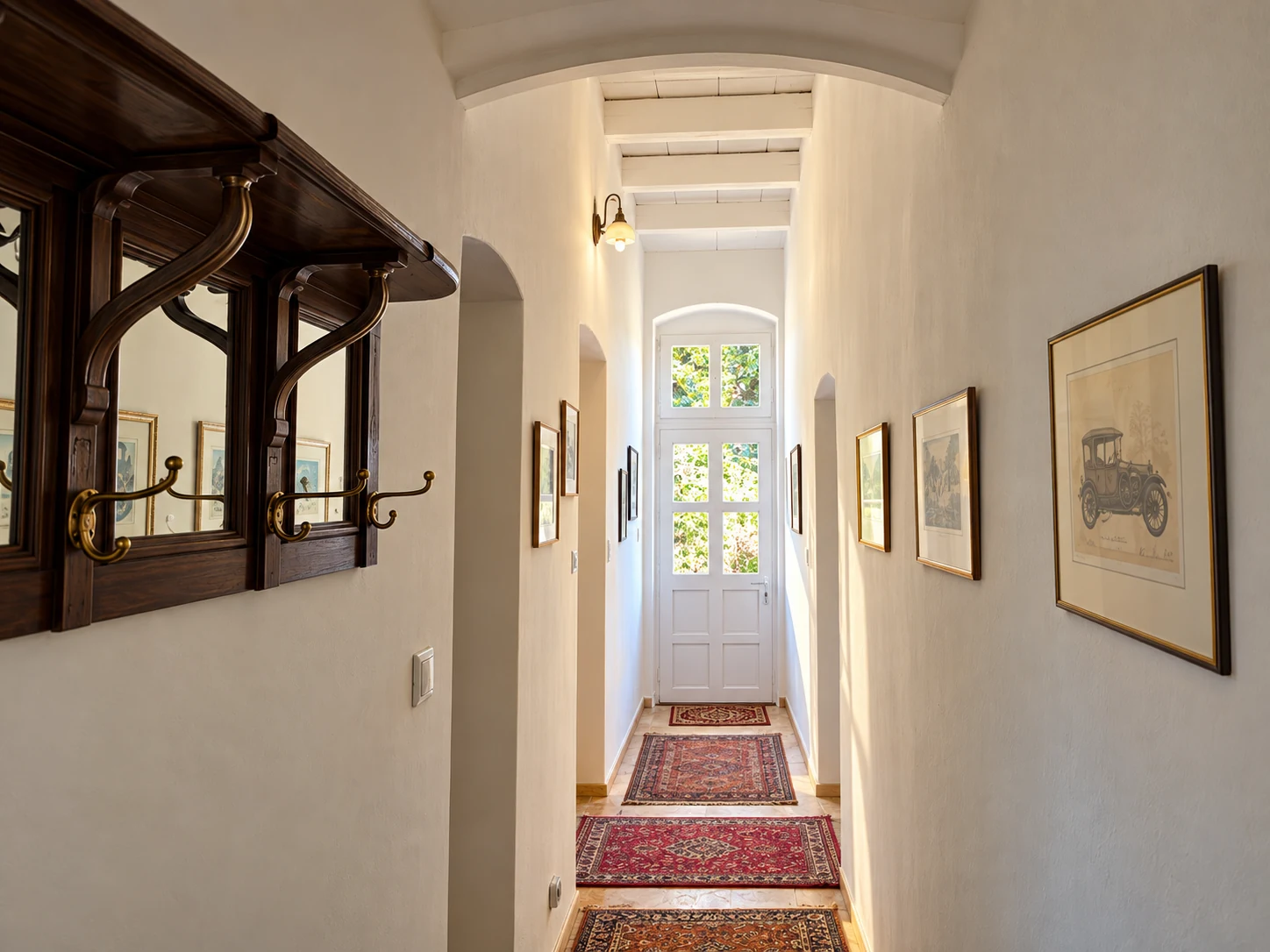 Heller Flur im Apartment Classic mit historischen Bildern und Teppichen